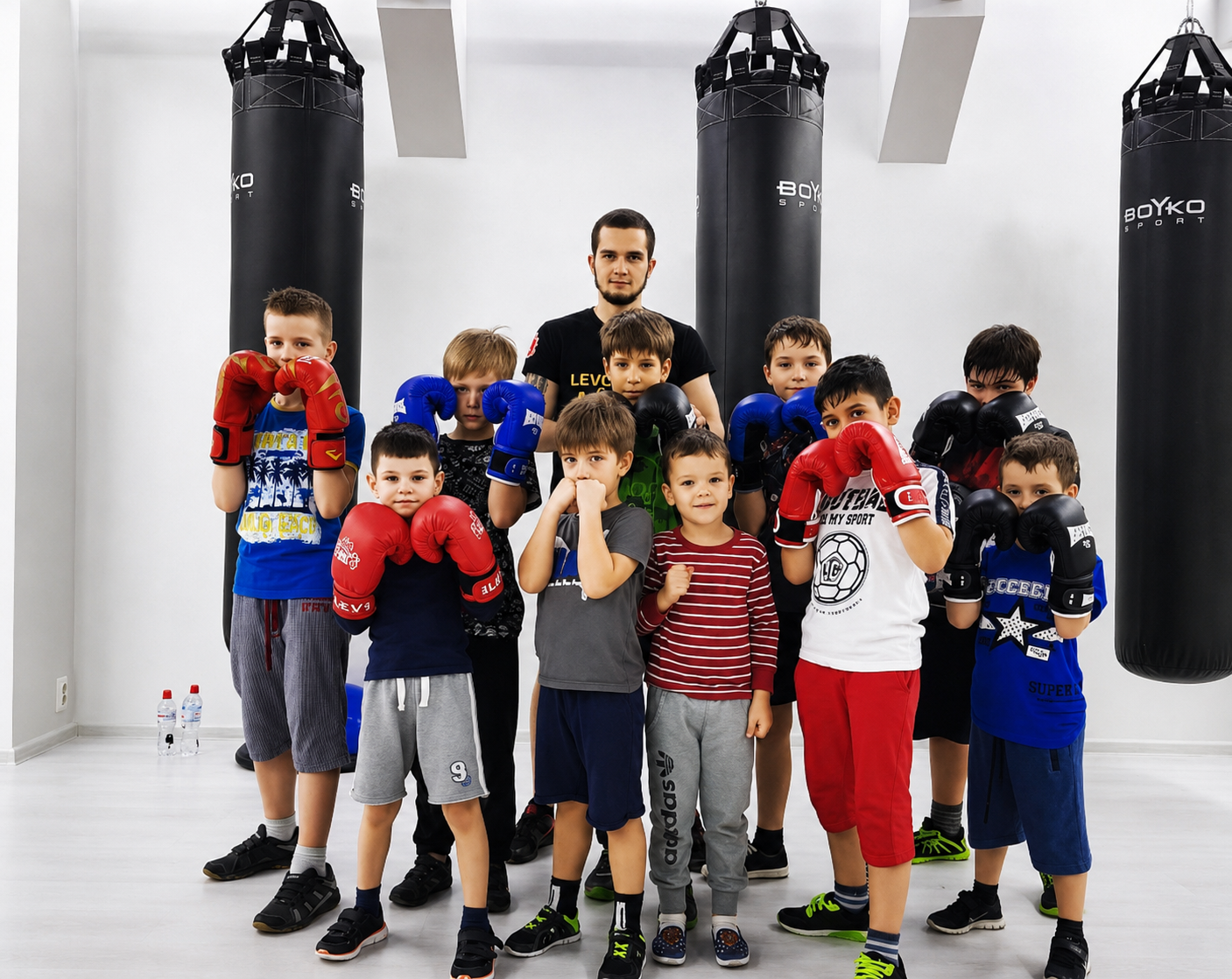 Nova Athletic coach with a group of young boxers in gloves