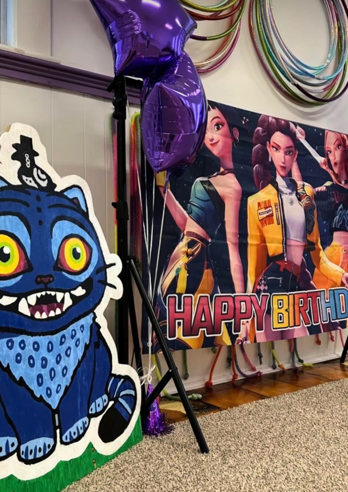 Birthday banner, balloons and decorations set up in the gym