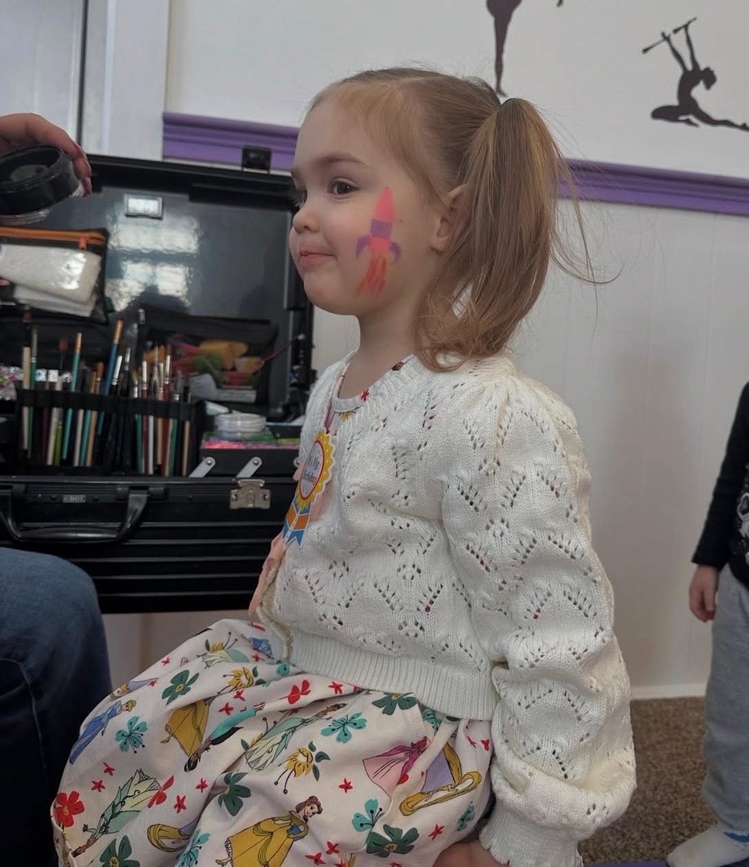 Birthday girl with a rocket painted on her cheek